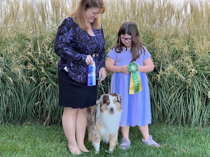 CH Crimson’s Blaze of Glory AX AXJ DCAT HIC with his handlers.